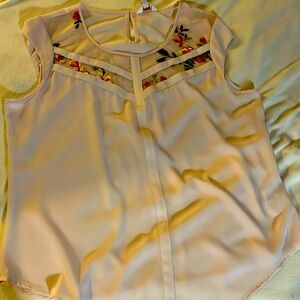 Soft pink embroidered top.